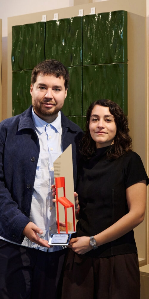 ious-studio-sol-sanchez-cimarelli-agustin-ros-portrait Sol Sánchez Cimarelli and Agustín Ros of IOUS Studio holding an award