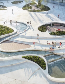 Public Space and Urban Landscape Aerial view of a landscaped public space with curved walkways, planted areas and people.